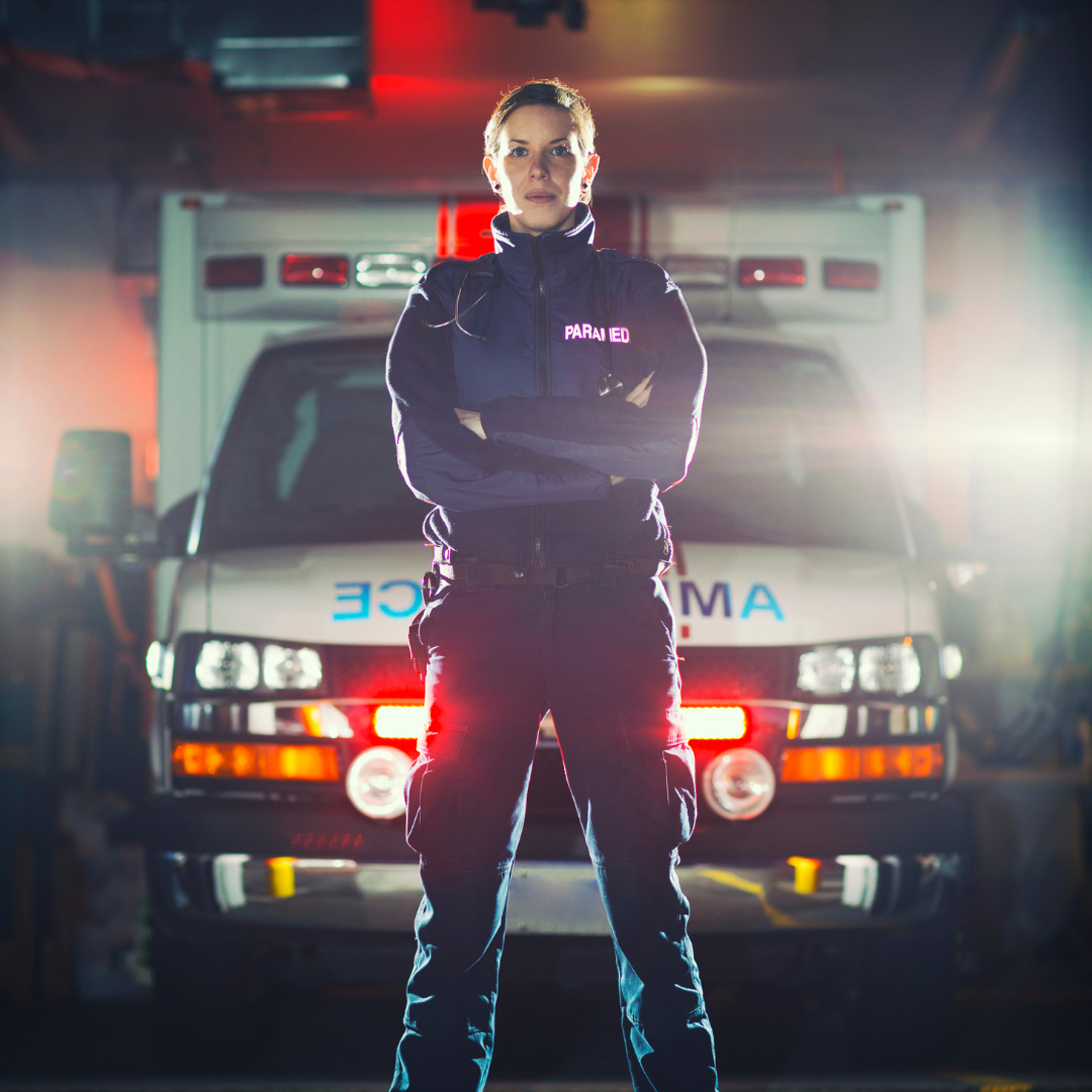 Paramedic standing in front of an ambulance