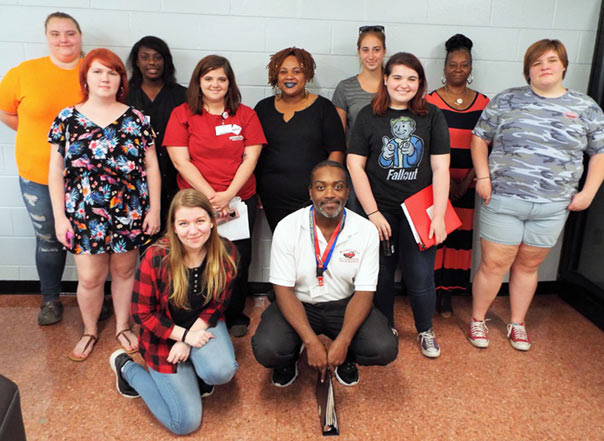 Several students lined up for a photograph in the college cafe