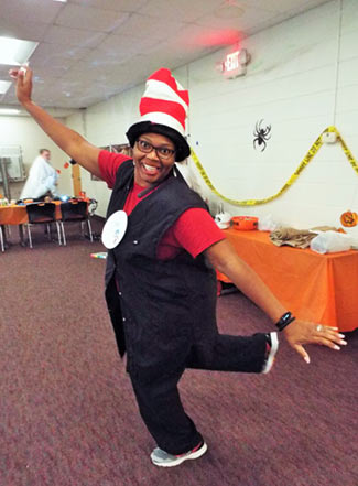 A student smiling at the camera while dancing at a college function